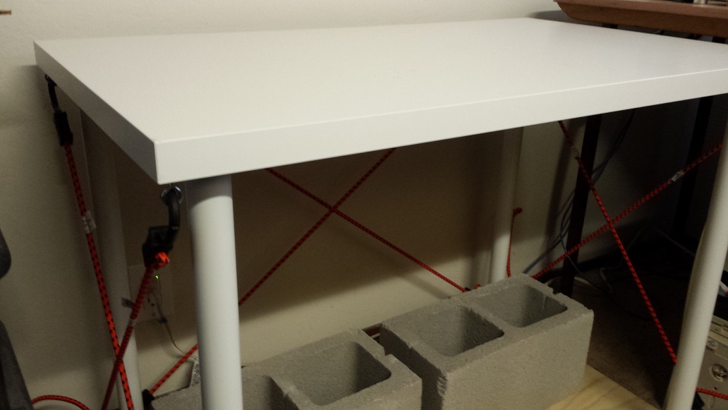 Stabilized table with bungee cords and blocks